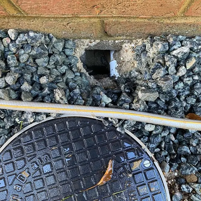 A hole near a manhole cover
