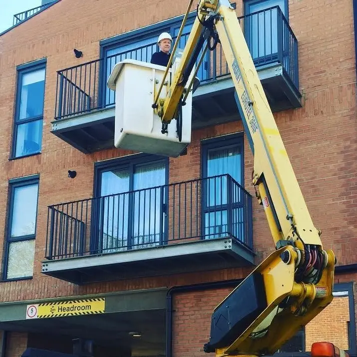Block of flats with a cherry picker in front of it